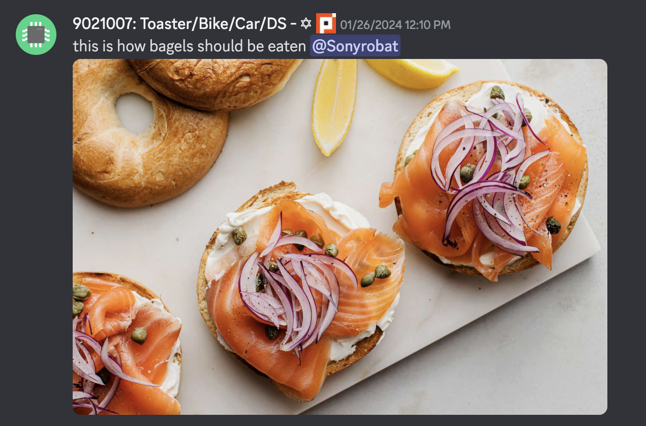 discord screenshot of message "this is how bagels should be eaten", attached to the message is an image of bagels with lox, cream cheese, onions, and capers.