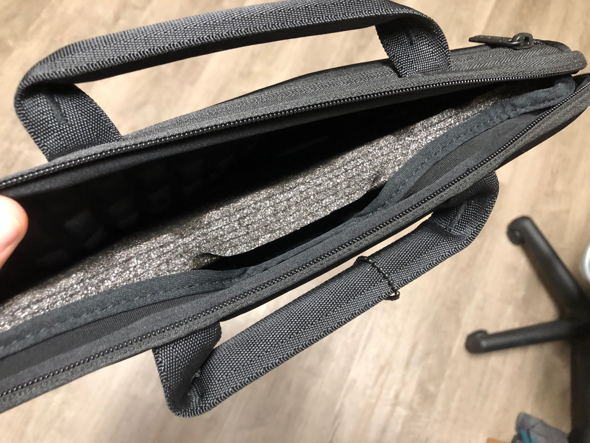 photo of top of bag, slightly open, showing black temporary foam pad.