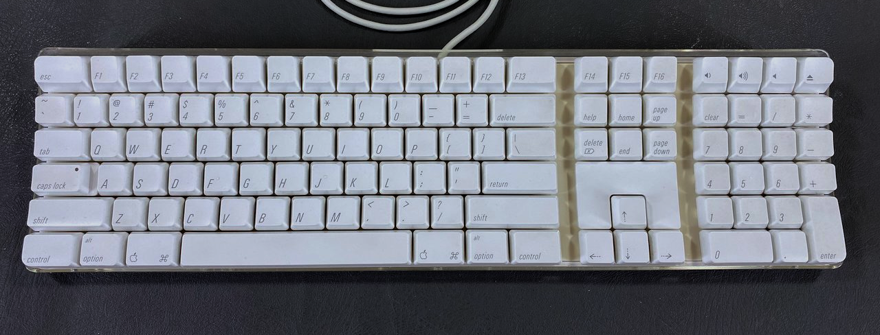 Photo of the iMac G4 and G5 external keyboard. The Command key also has the Apple logo printed on it, and the Alt key also has the word "option" printed on it.