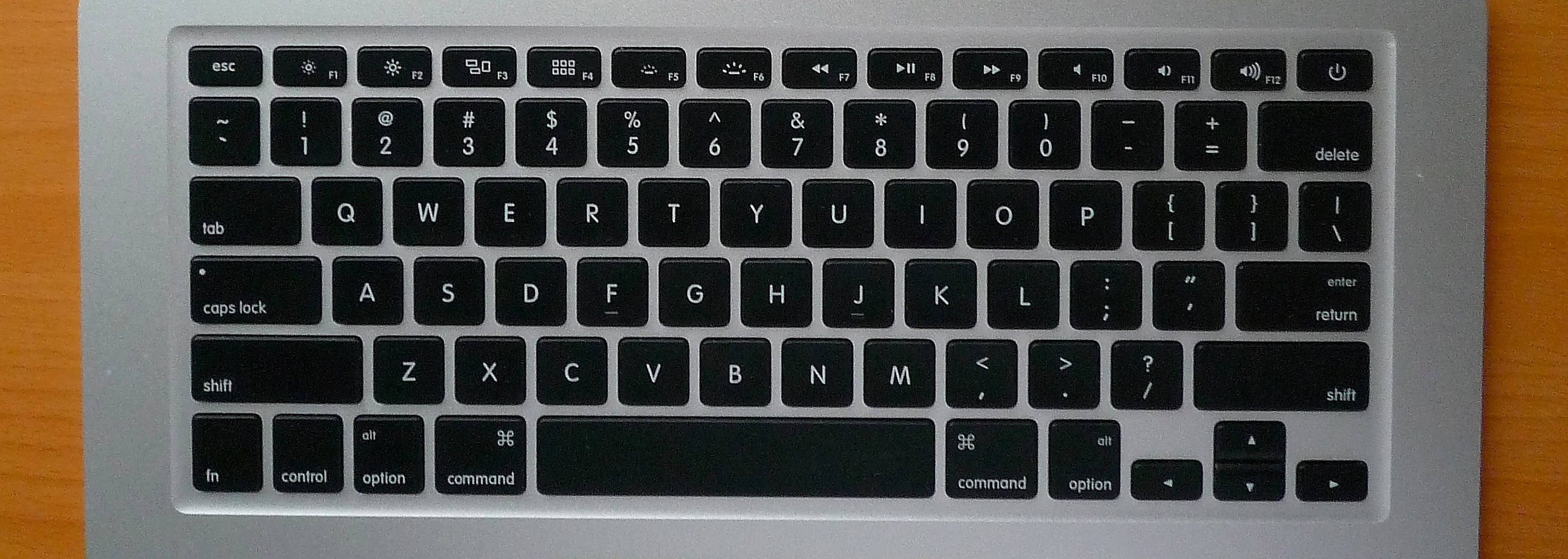 Photo of a 13" Unibody Macbook Pro keyboard. Alt key says "Alt Option", Command Key has Command symbol says "Command", Enter key says "Enter Return"