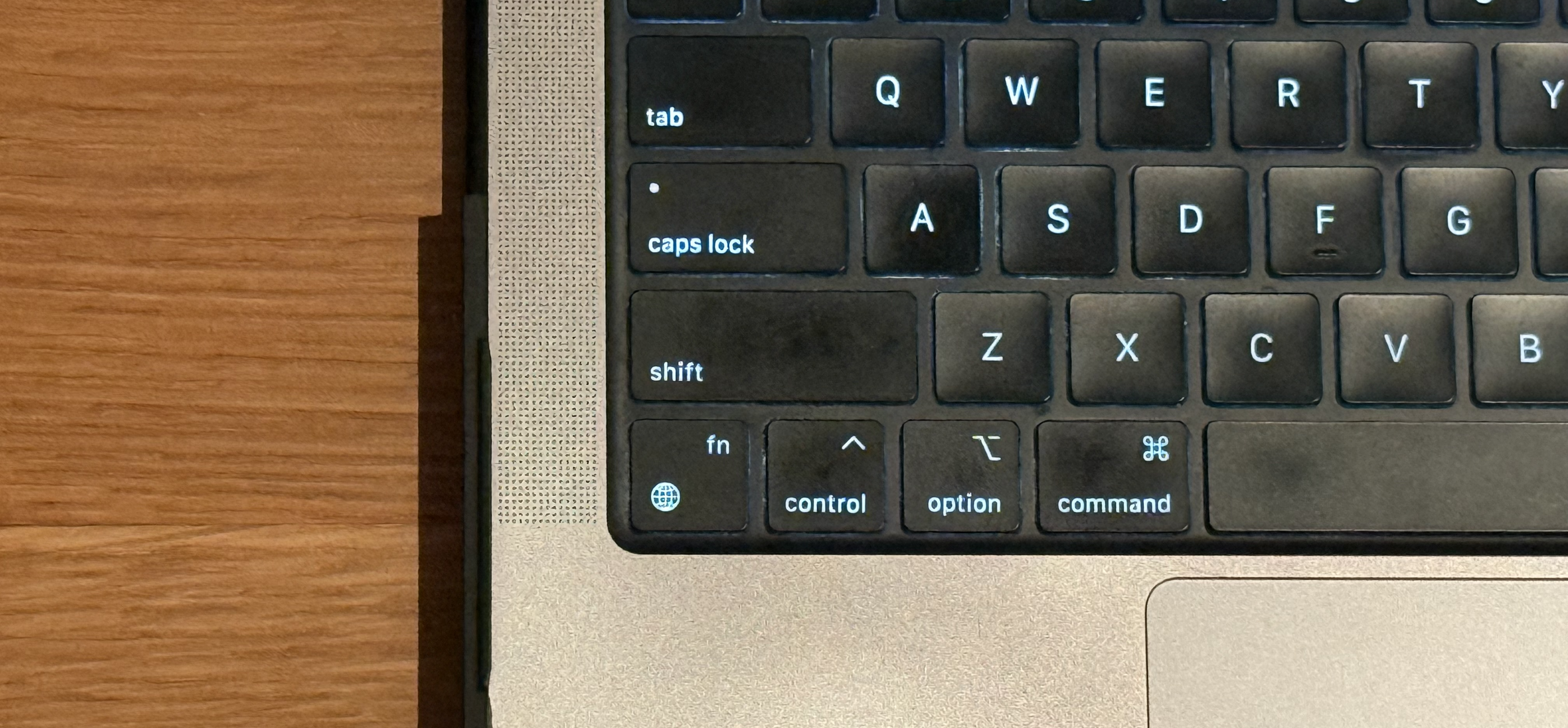Photo of 2021 MacBook Pro 14-inch keyboard. Fn (function) key now has a globe icon at the bottom, and the text "fn" on top.
