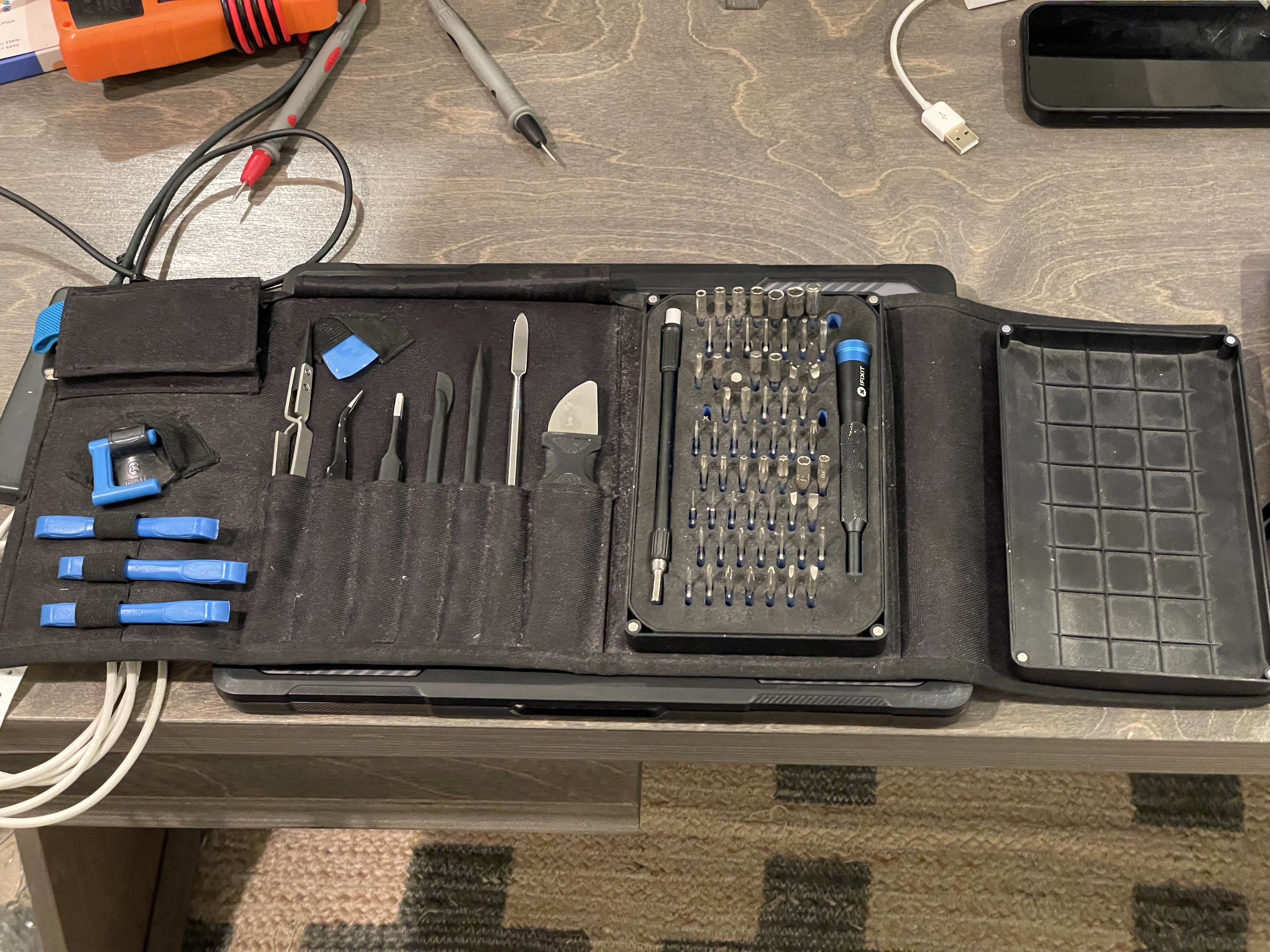 iFixit Pro Tech Toolkit. A couple bits are missing, the scredriver has scratches, the tweezers are missing paint, and all-but-one of the guitar picks are gone.